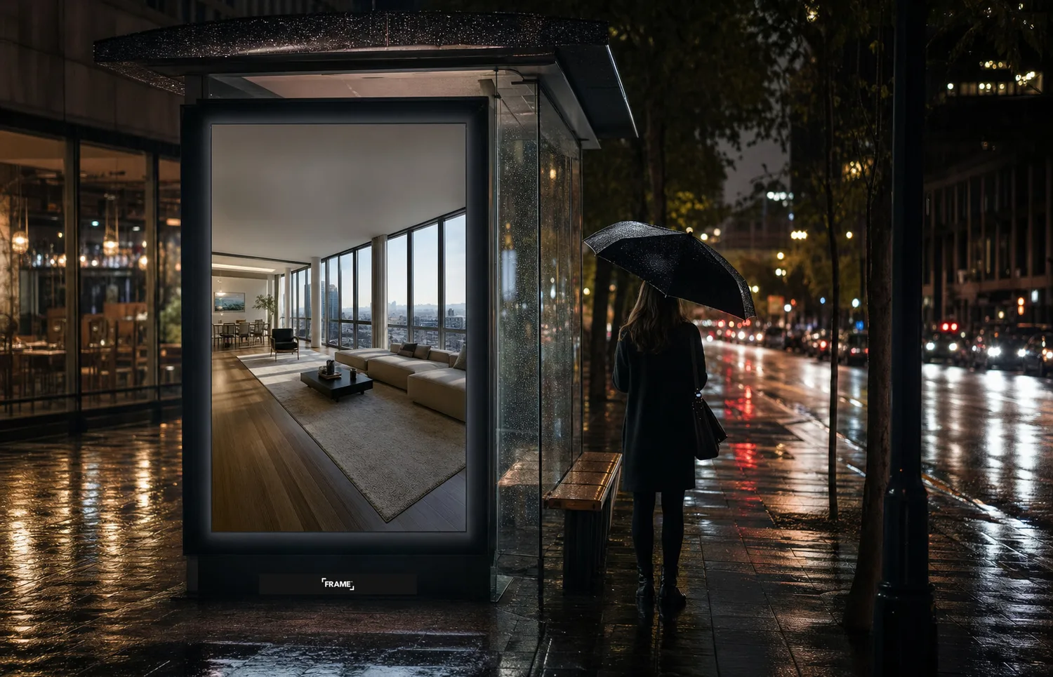 Apartment listing creative on a bus shelter panel at night, FRAME nameplate bottom-center on the rail
